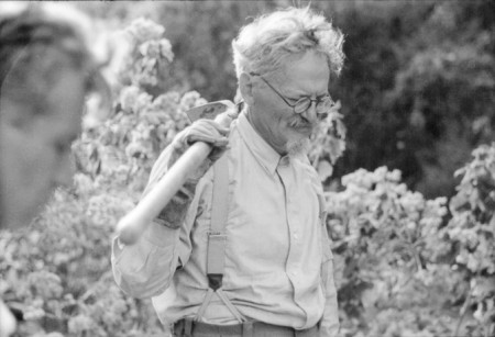 Leon Trotsky, black and white picture, carrying a hoe